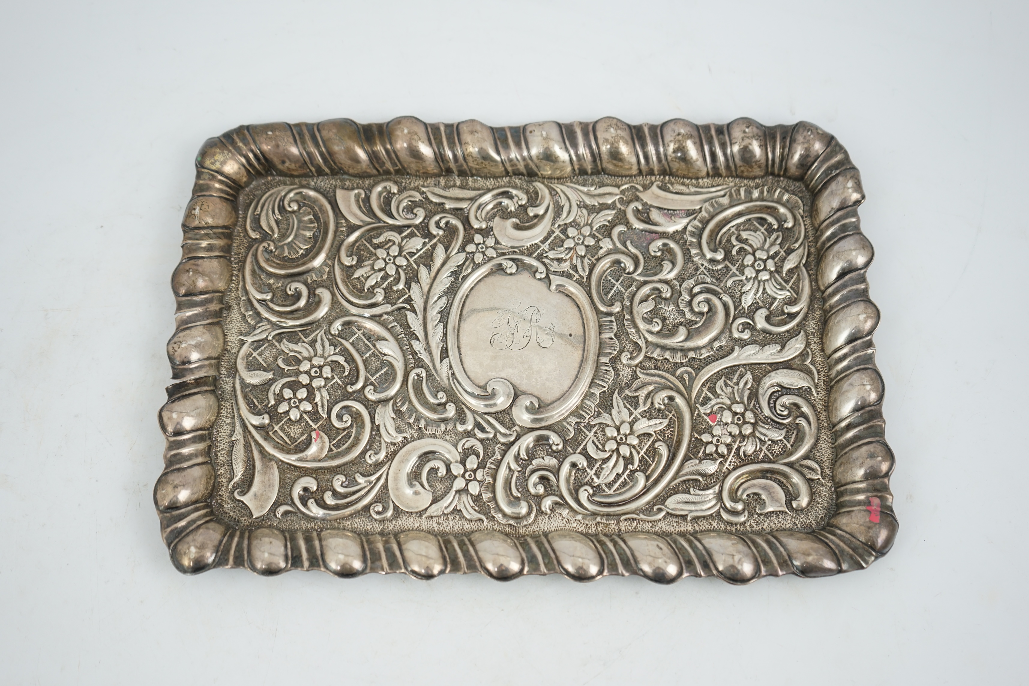 An Edwardian repousse silver dressing table tray, A&J Zimmerman, Birmingham, 1901, 30cm